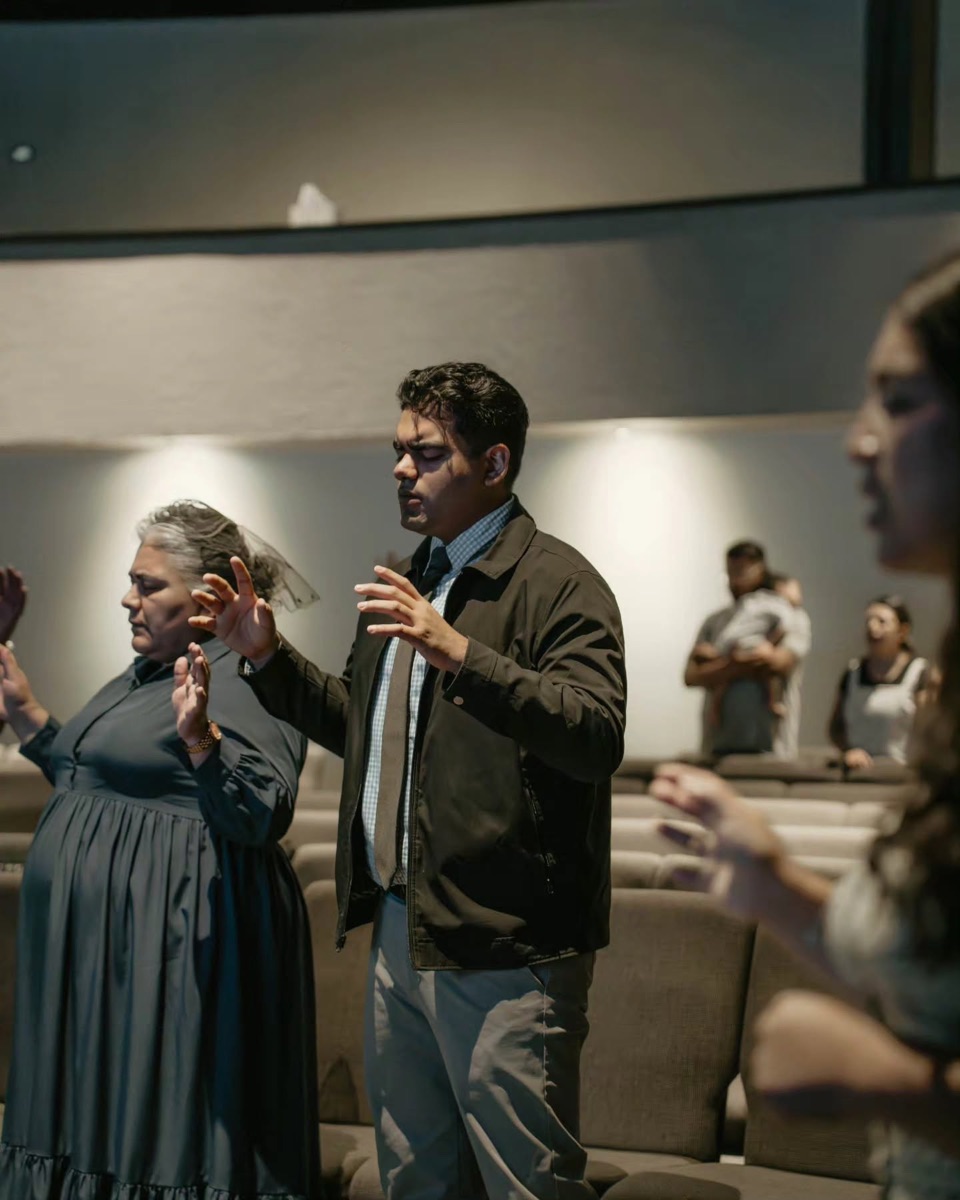 Pastor praying with the congregation